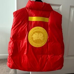 Canada Goose Red Vest with yellow embroidered patch on back. Unisex size M.